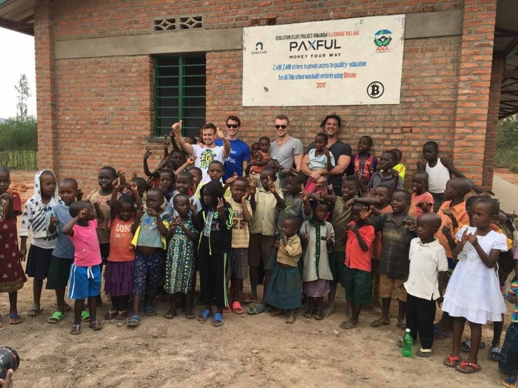 Paxful team with African children
