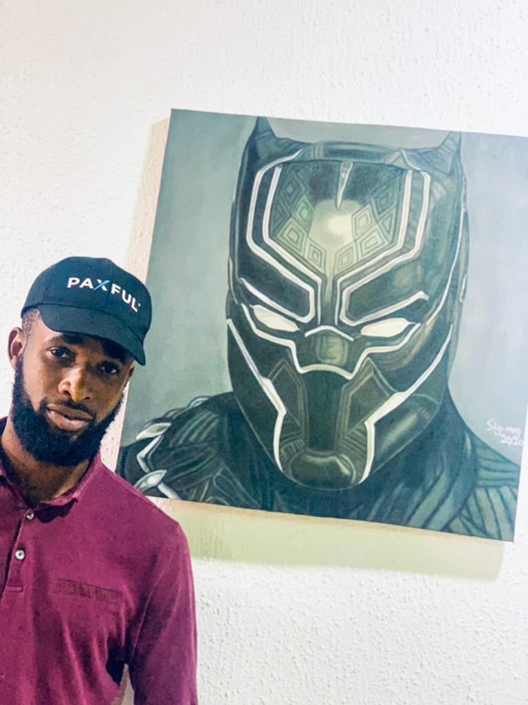 Joseph with the artwork he bought with BTC